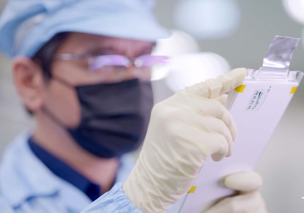 A technician examines a ProLogium next generation Lithium ceramic battery for EVs.